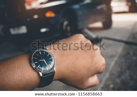 Hand of man\'s Wrist Watch Waiting for the car repair ,Llong time concept.