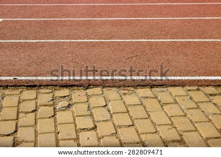 Two paths in different terrains: cobblestone and running track