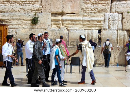 JERUSALEM, ISRAEL - MAR, 23, 2015 - A bar mitzvah ceremony takes place in the Western Wall and is followed by a soldier