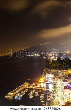 Night scene of Sorrento, the pier with lots of yachts, a corner of the cityscape on a summer night, Amalfi coast, Italy