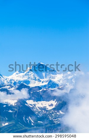 View of the famous peak Jungfrau of the swiss Alps on Bernese Oberland in Switzerland. One of the main summits of Bernese Alps, located betweensouthern canton of Bern and northern canton of Valais.