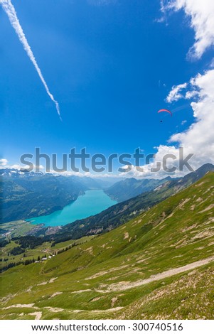 Aerial view of the Brienz lake and the alps from the mountains on hiking trail on Bernese Oberland near the famous tourism region of Interlaken, Jungfrau region, Switzerland.