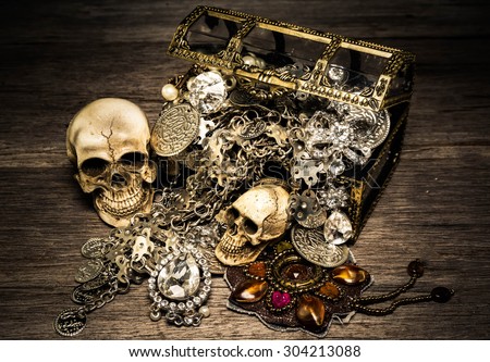 Skull and treasure chest on the old wooden table ,Vintage style, still life