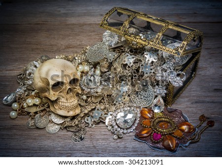 Skull and treasure chest on the old wooden table ,Vintage style, still lift