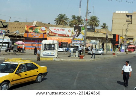 BAGDAD, CITY OF SADR - AUGUST 22: A cross-roads in city of Sadr on August 22, 2011. The leader of Mahdi Army, Muqtada Al Sadr\'s photo is posted on utility pole.
