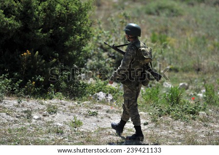 TURKISH-SYRIAN BORDER -JUNE 19, 2011: Unidentified Turkish soldier guard along the border, due to the war in Syria on June 19, 2011 on the Turkish - Syrian border.