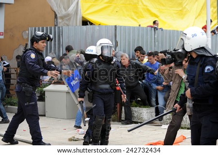 ISTANBUL - MAY 1: Many people can\'t take part in May Day march on May 1, 2009 in Istanbul. Police blocked all the ways to Taksim Square to prevent the activists from joining their mates. Policeman