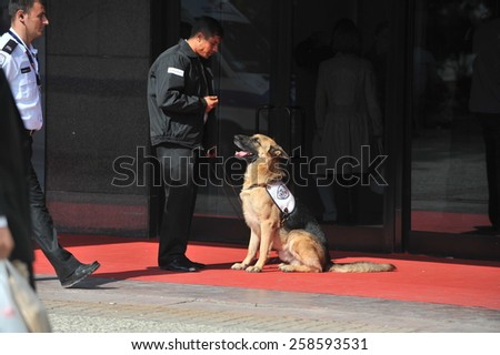 ISTANBUL, TURKEY - DECEMBER 13:  Exhibition devoted to costume jewellery,  security dog at the fair entrance with security guard  on December 13, 2011 in Istanbul, Turkey.