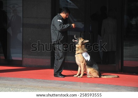 ISTANBUL, TURKEY - DECEMBER 13:  Exhibition devoted to costume jewellery,  security dog at the fair entrance with security guard  on December 13, 2011 in Istanbul, Turkey.