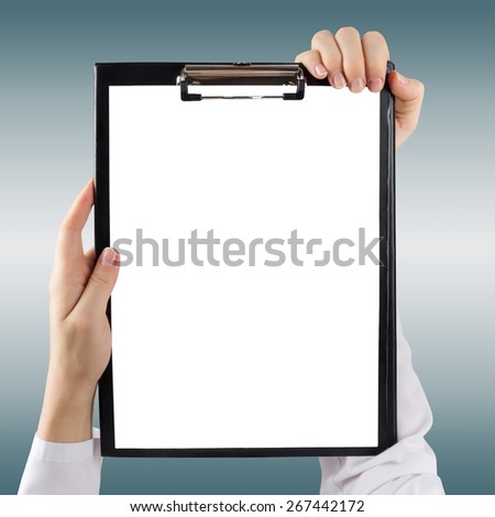 Female doctor\'s hand  holding medical clipboard with blank sheet of paper blurred background. Concept of Healthcare And Medicine. Copy space