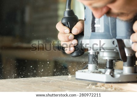 Close-up of carpenter cutting a wooden plank.  Selective focus. Copy space
