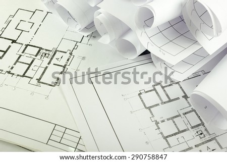Architectural project, blueprints, blueprint rolls on plans. Engineering tools view from the top. Copy space. Construction background.