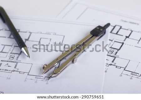 Architectural project, blueprints and divider compass, pencil on plans. Engineering tools view from the top. Copy space. Construction background.