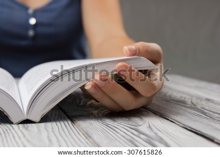 Closeup hand open book for reading concept background