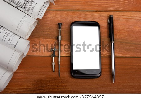 Workplace of architect - Architectural project, blueprints, blueprint rolls and divider compass, pen, smartphone on wooden table. Engineering tools view from the top. Construction background.