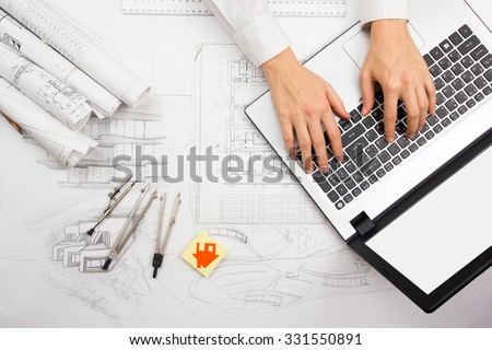 Architect working on blueprint. Architects workplace - architectural project, blueprints, ruler, calculator, laptop and divider compass. Construction concept. Engineering tools. Top view