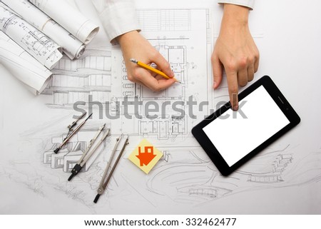 Architect working on blueprint. Architects workplace - architectural project, blueprints, ruler, calculator, laptop and divider compass. Construction concept. Engineering tools. Cope space for text.