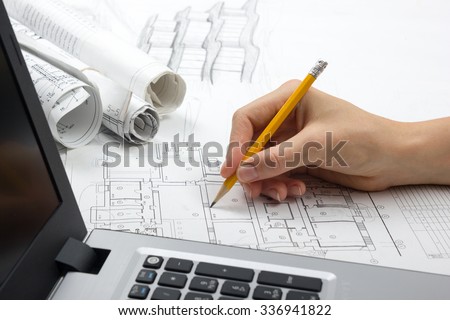 Architect working on blueprint. Architects workplace - architectural project, blueprints,  laptop. Construction concept. Engineering tools