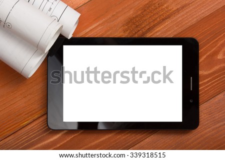 Workplace of architect - Architectural project, blueprints, blueprint rolls and tablet pc or smartphone with empty white screen on wooden table. Engineering tools. Construction background. Top view