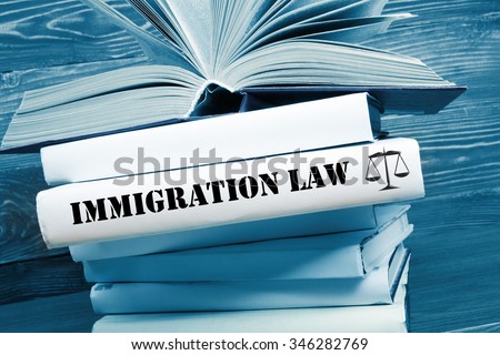 Law concept - Law book with Immigration Law word on table in a courtroom or law enforcement office. Toned image