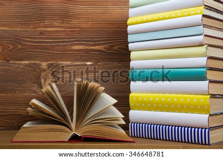 Open book, hardback books on wooden background. Back to school.  Copy space for text