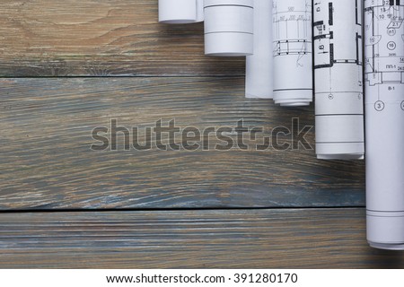 Architect worplace top view. Architectural project, blueprints, blueprint rolls on wooden desk table. Construction background. Engineering tools. Copy space