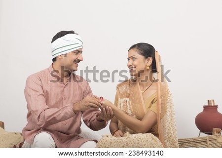 Husband gifting gold bangles to wife