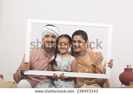Happy rural family with frame