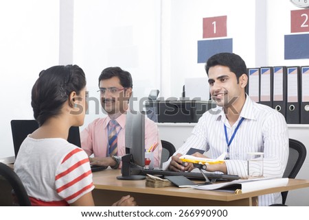Bank manager talking with the lady customer