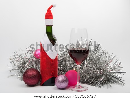 Wine bottle in Santa Claus\'s suit on a light background