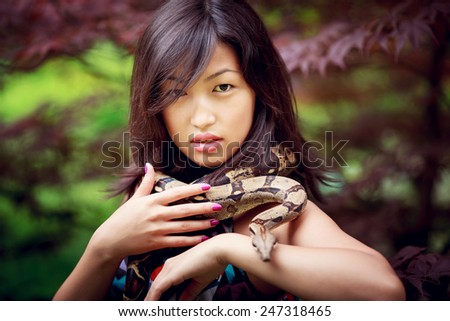 Young, beautiful asian woman with snake outdoor