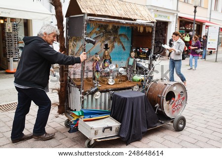 Potsdam, Germany, May 11 2013: Man carries a mini musical theater on the street