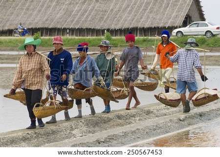 HUAHIN, THAILAND - MAY 13, 2008: Unidentified people work at the salt farm on May 13, 2008 in Huahin, Thailand. Salt production is one of the main industries in Huahin area, Thailand.