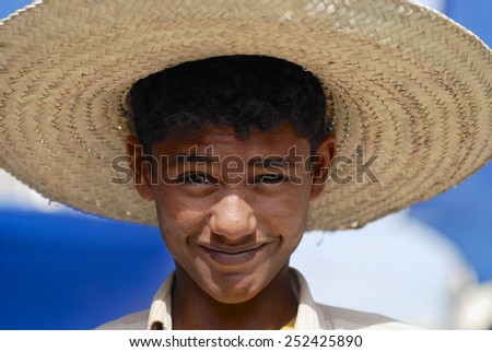 TAIZZ, YEMEN - SEPTEMBER 16, 2006: Portrait of unidentified young man wearing a straw hat on September 16, 2009 in Taizz, Yemen.