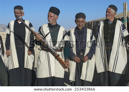 ISFAHAN, IRAN - JUNE 22, 2007: Unidentified men wear traditional dresses circa Isfahan, Iran. Some Bakhtiari people in Iran still follow nomadic lifestyle and wear traditional dress daily.
