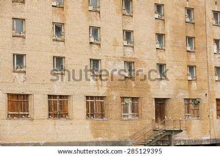 LONGYEARBYEN, NORWAY - SEPTEMBER 03, 2011: Birds sit on nests in the windows of the building in the abandoned Russian arctic settlement Pyramiden, Norway.