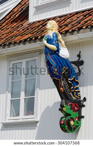 DROBAK, NORWAY - JULY 08, 2006: Exterior of the ship figurehead attached to the facade of a house in Drobak, Norway.
