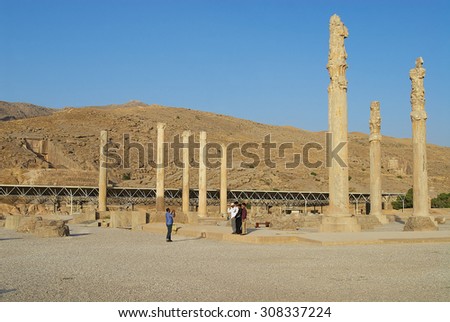 SHIRAZ, IRAN - JUNE 19, 2007: Unidentified people make travel photo at the ruins of Persepolis in Shiraz, Iran. Persepolis is a UNESCO World Heritage site.