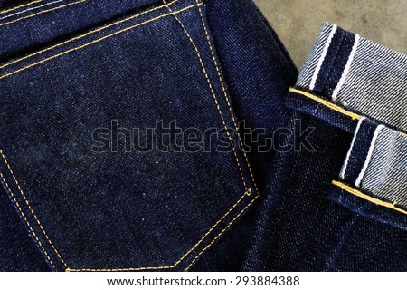folded men\'s denim jeans / close up on folded men\'s denim jeans with folded on semen floor