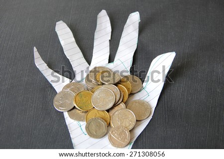 Creative paper craft with financial concept. Hand full of foreign currencies.