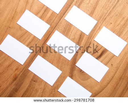 Display of different white cards to design on wooden table.