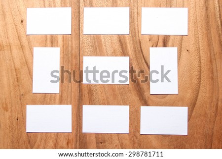 Display of different white cards to design on wooden table.