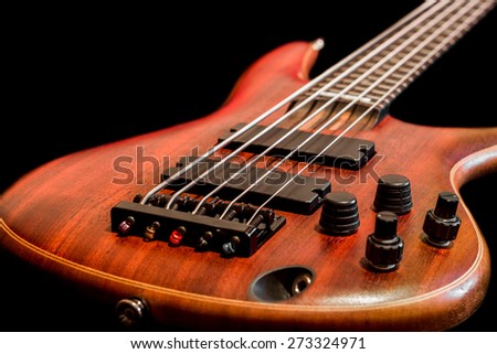 Bass guitar body view (low key, shallow depth of field)