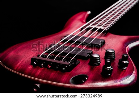 Bass guitar body view (low key, shallow depth of field)