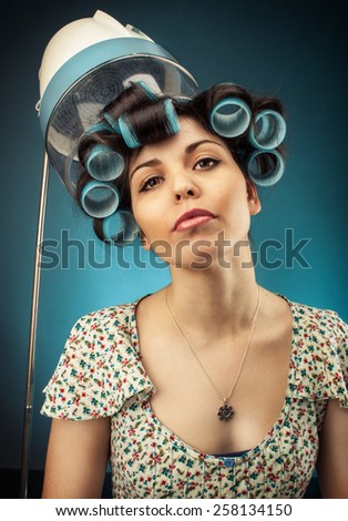 Photo of a young woman in  hair curlers,  hood dryer,\
added noise on back ground Retro Look