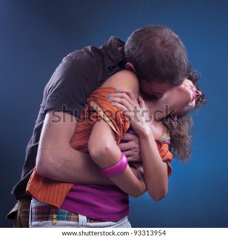 Man with arms around woman