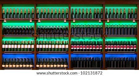 shelf with rows of wine bottles