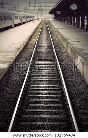Empty railway track between platforms at train station