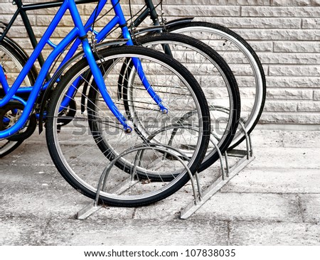 Front wheels of three bicycles in a row