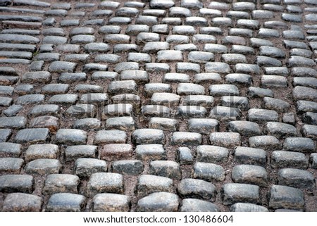 Close up of ancient street with cobblestones in early evening light